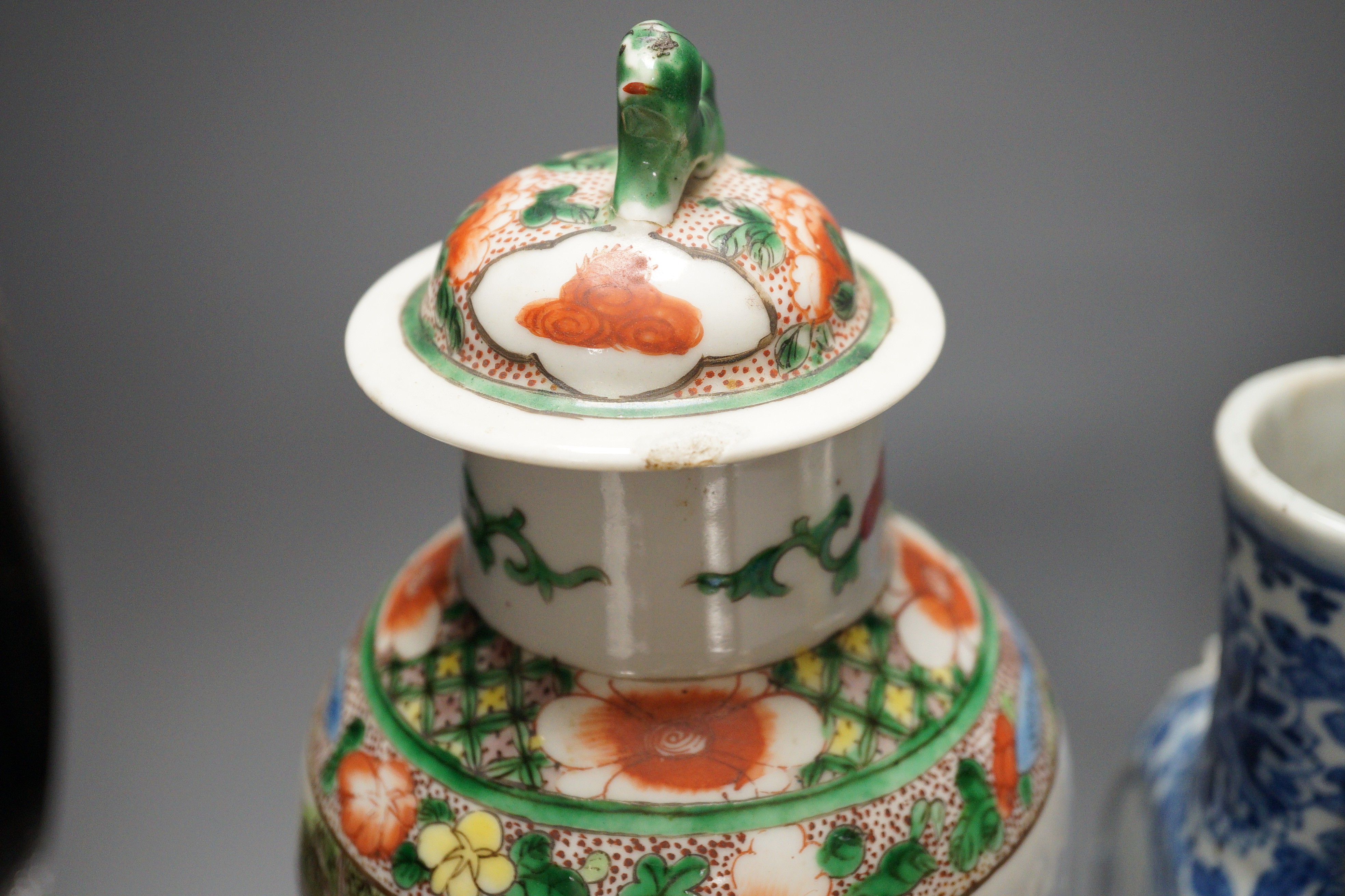 A Chinese famille verte vase and cover, a yellow ground ‘soldiers’ vase, a blue and white moonflask and a similar’dragon’ sleeve vase, all late 19th/early 20th century, Tallest 33cm